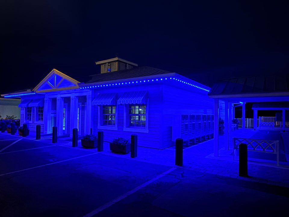 Commercial building washed in blue permanent lighting at night