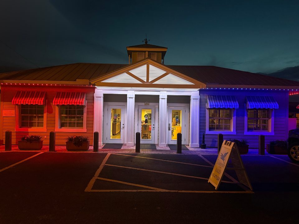 Commercial building entrance lit in red, white, and blue