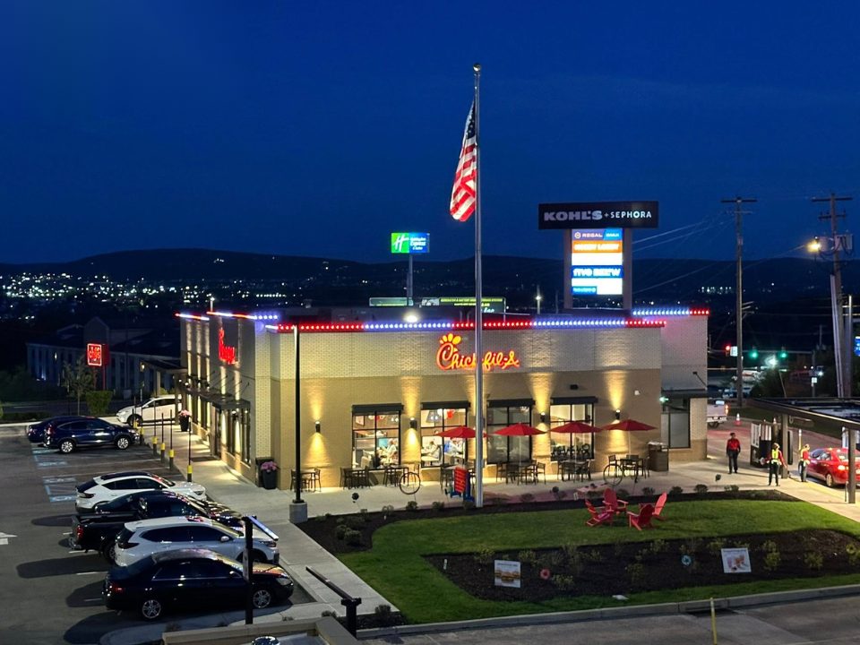Commercial restaurant storefront with permanent lighting outlining the building at dusk