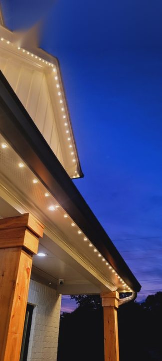 Close-up of soffit and eave lighting along a roofline at dusk