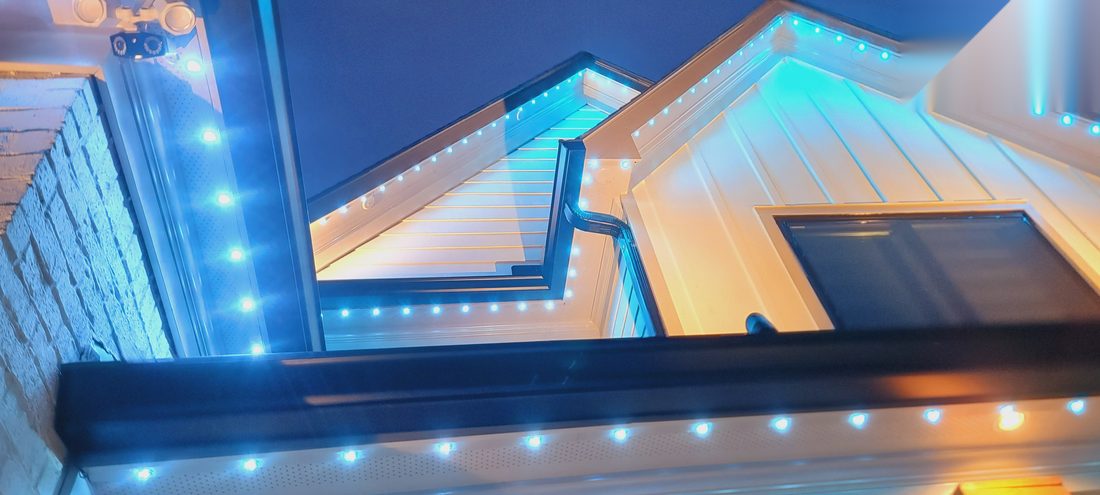 Close-up angle of blue permanent eave lighting