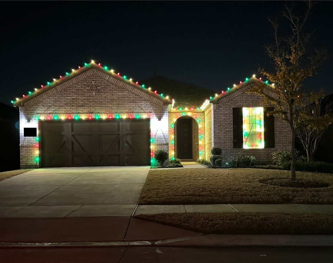 Home decorated in classic red, green, and warm white holiday lights
