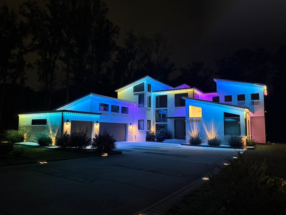 Modern home with colorful RGB permanent lighting along the roofline
