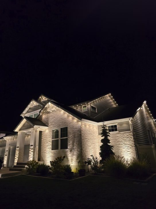 Home exterior fully lit at night for visibility and security
